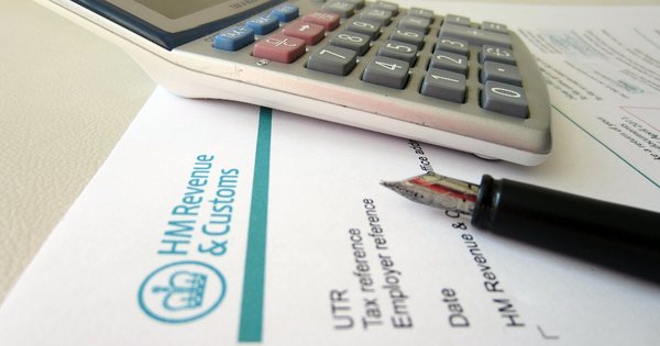 A photo of a calculator next to a letter from HM Revenue and Customs.