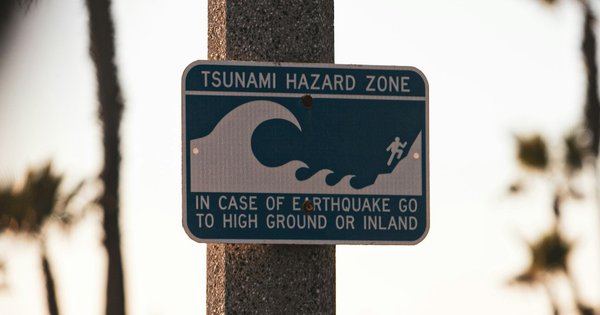 A tsunami hazard zone sign at a beach.